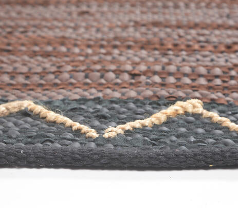 Rug shown partly turned back to reveal its reverse