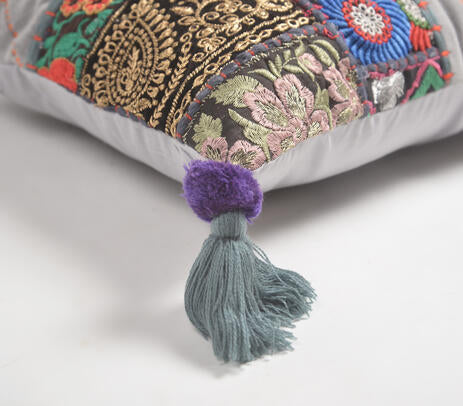 Embroidered patchwork cushion cover in an eclectic room
