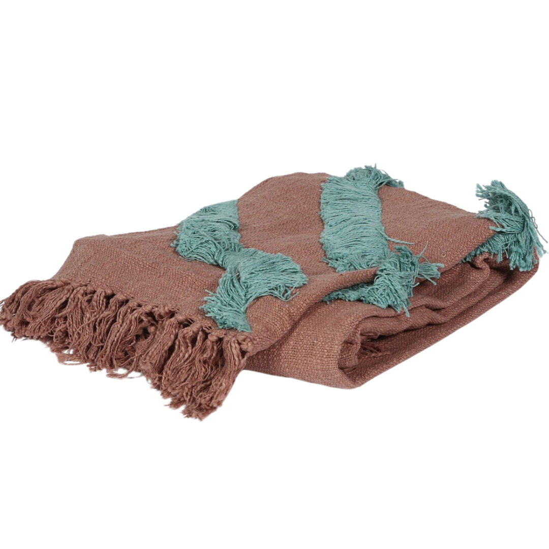 Dusty pink throw blanket paired with cushions