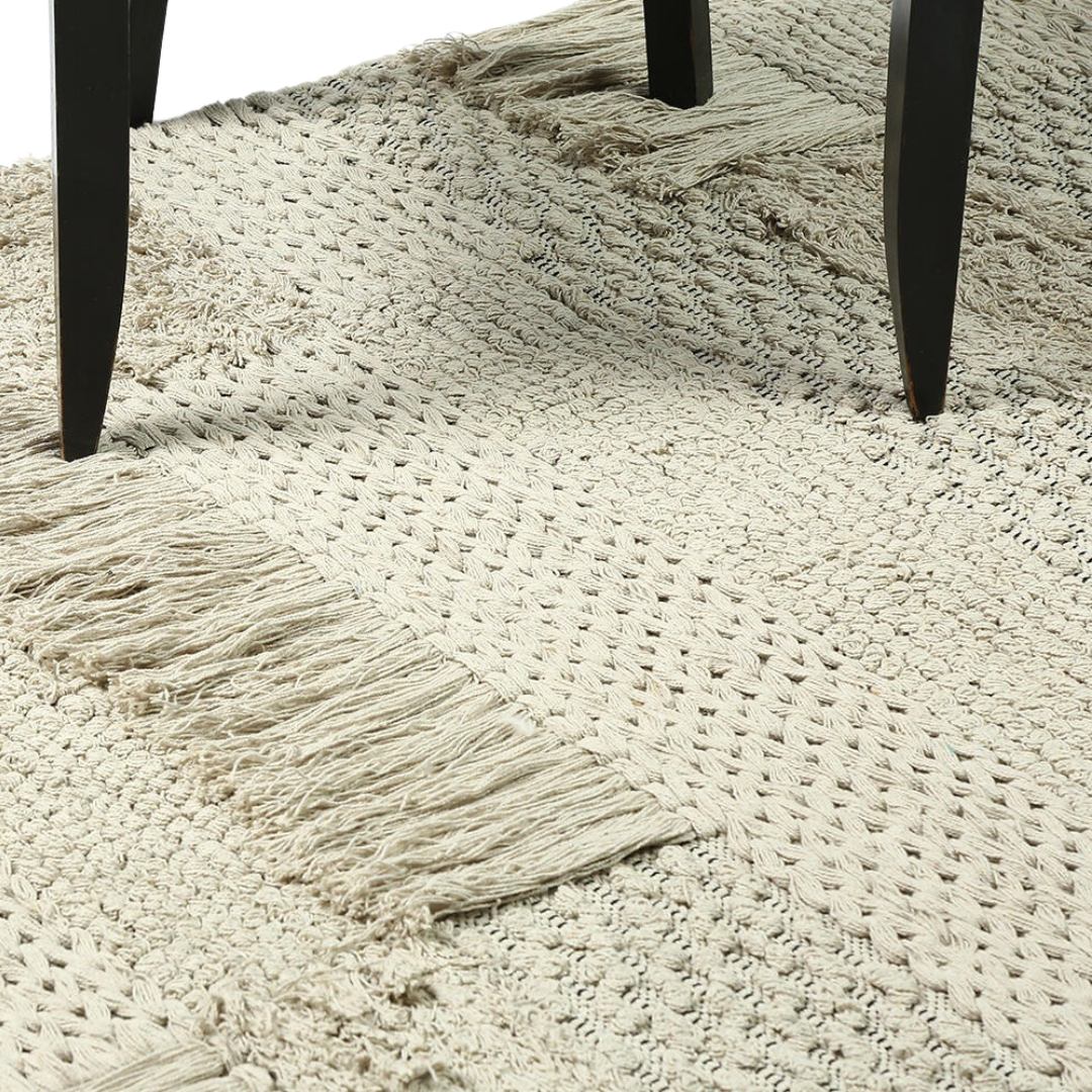 Rug shown partly turned back to reveal its reverse