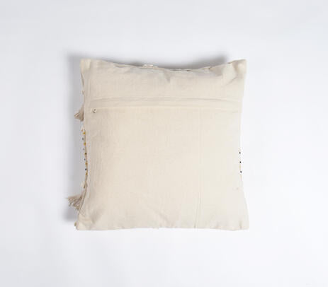 White fringed cushion cover detail in a bright room
