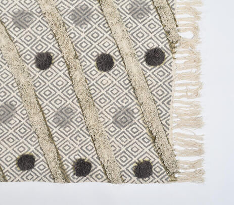 Pom pom throw blanket paired with cushions