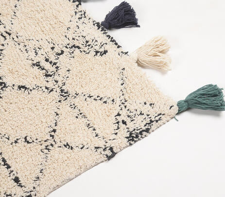 Bath mat shown partly turned back to reveal its reverse