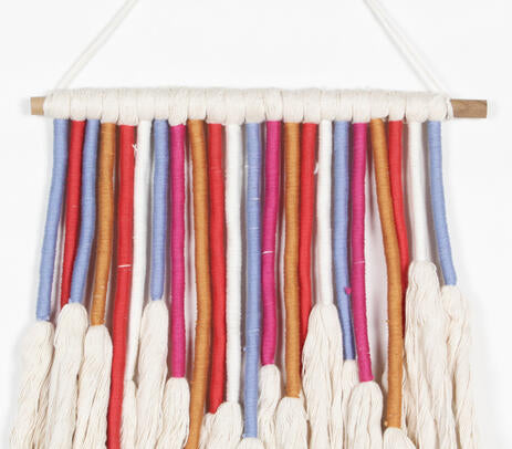 Colourful rope wall hanging styled in a kids room