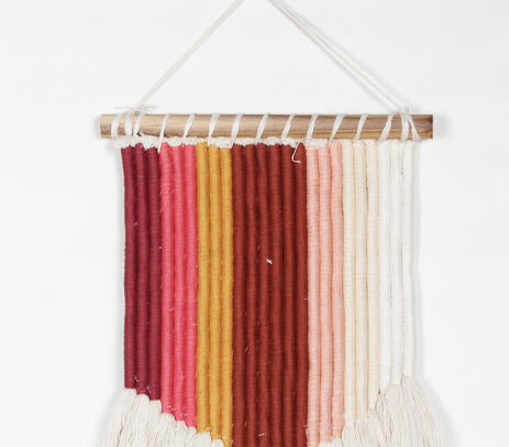 Tasseled rope wall hanging in a styled room