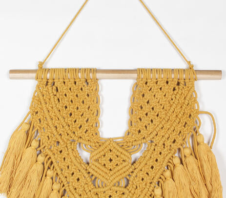 Mustard macrame wall hanging shown with wood dowel detail