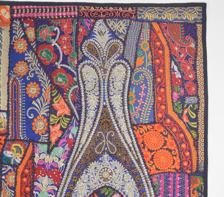 Upcycled fabric wall hanging on a painted plaster wall