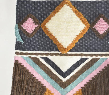 Soft blue wool wall hanging shown in full against a neutral wall