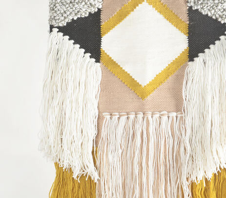 Diamond tufted wool wall hanging detail of the wood rod
