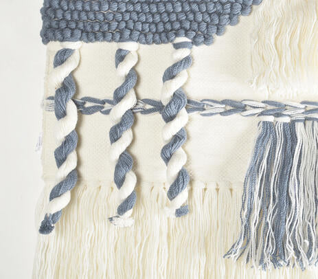 Tufted abstract wool wall hanging above a sofa