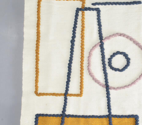 Abstract wool tassel wall hanging shown with hanging rod detail