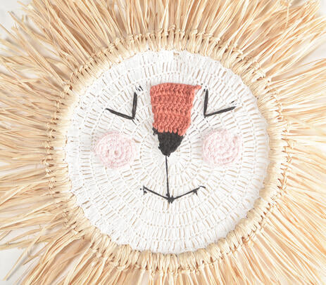 Cotton lion wall hanging in a styled kids reading nook