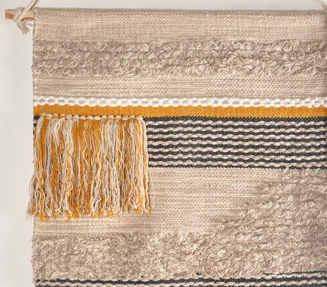 Multicolour cotton fringe wall hanging shown with hanging rod detail