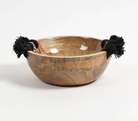 Tasseled wooden bowl paired with tableware