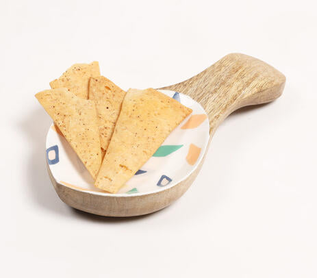 Geometric wood platter paired with tableware