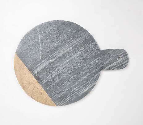 Round chopping board paired with kitchen items