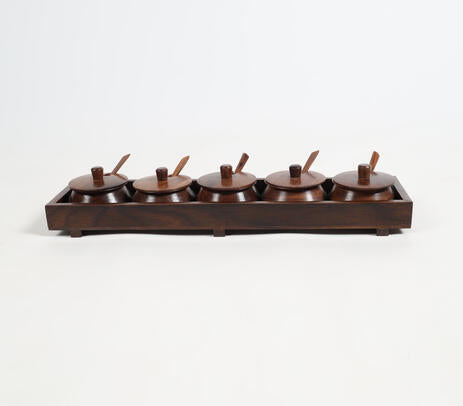 Rosewood condiment set paired with utensils