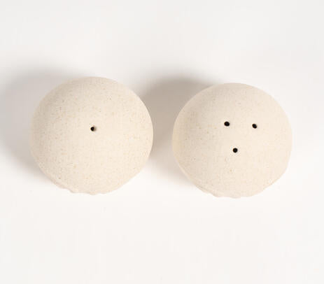 Ceramic salt pepper shakers paired with tableware