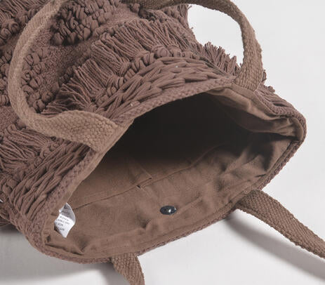 Cocoa tufted tote bag tassel close-up