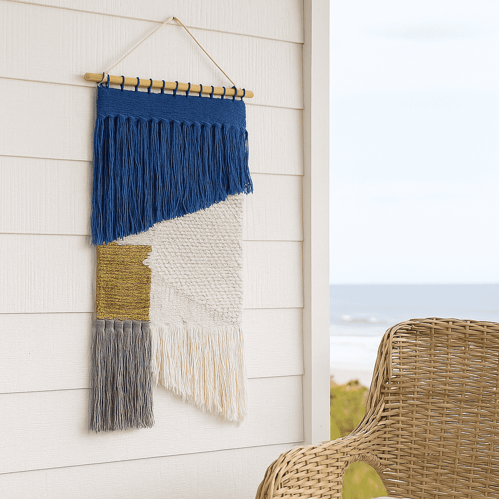 Coastal tasseled wall hanging styled in a coastal living room