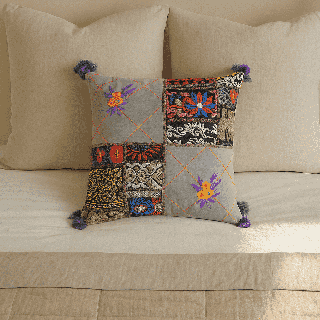 Embroidered patchwork cushion cover styled on a sofa