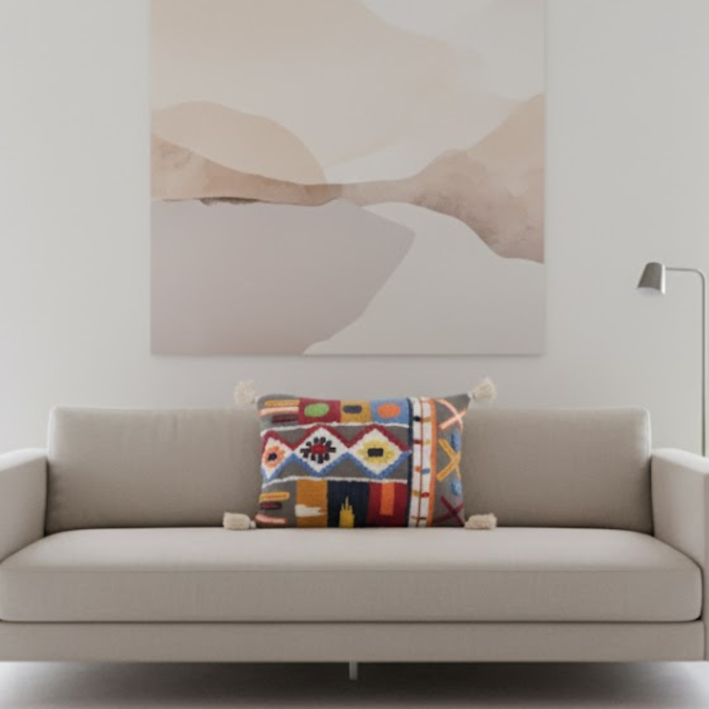 Embroidered tasseled lumbar cushion cover paired with other cushions