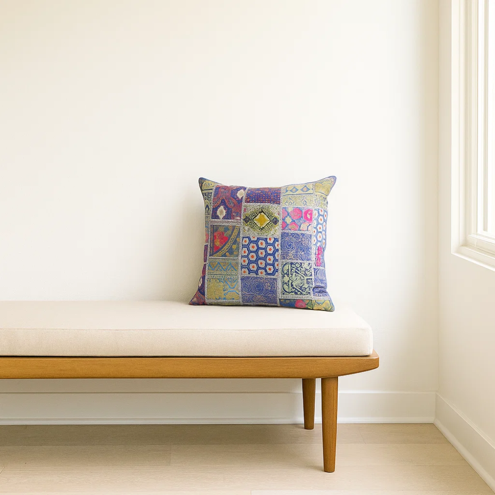 Upcycled embroidered cushion cover styled on a sofa