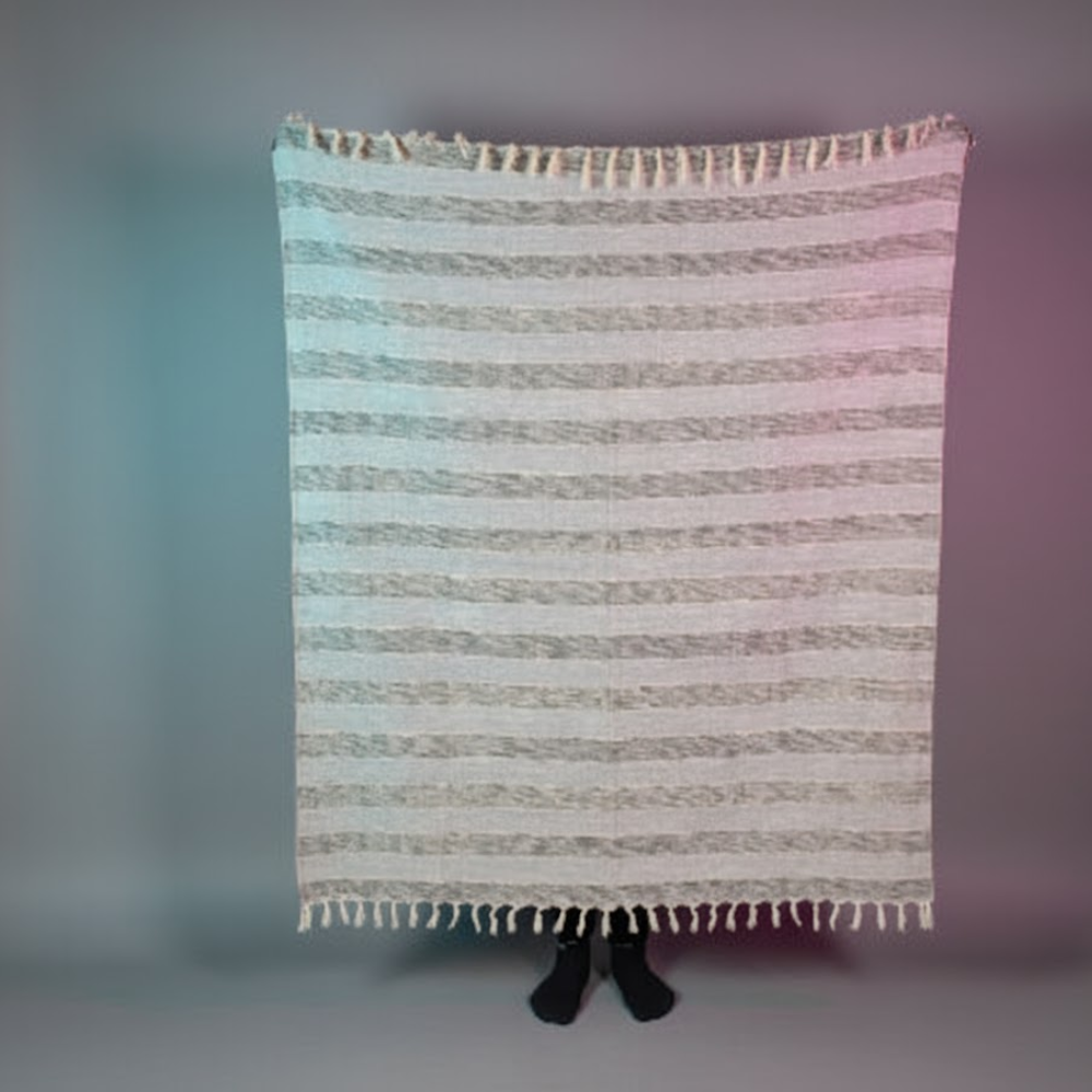 Greyscale throw blanket on a sofa