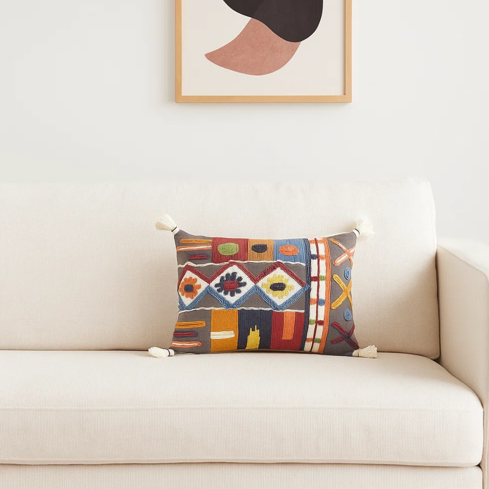 Embroidered tasseled lumbar cushion cover styled on a sofa