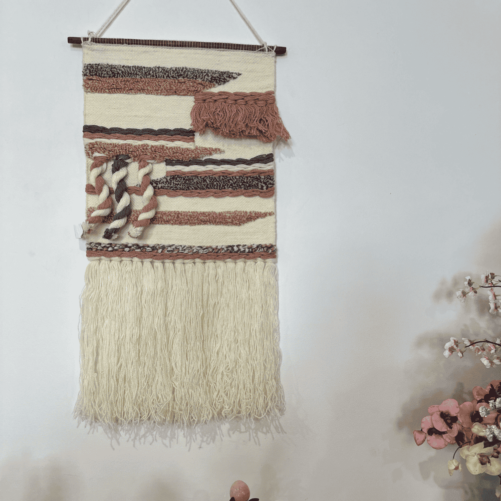 Dusty pink and blue wool wall hanging above a console table