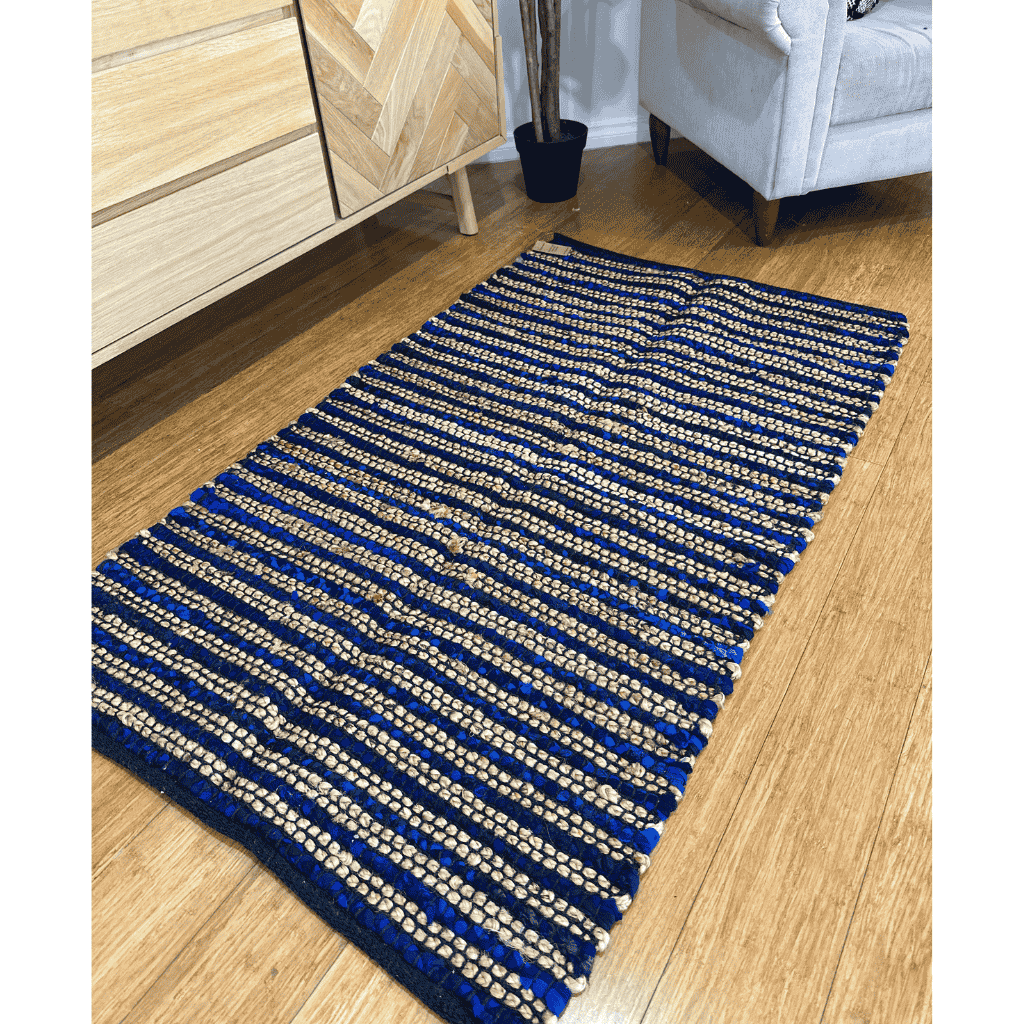 Rug shown partly turned back to reveal its reverse