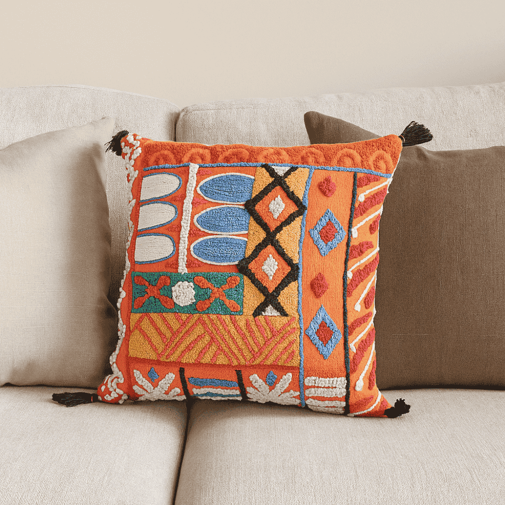 Tangerine embroidered cushion cover at an angle