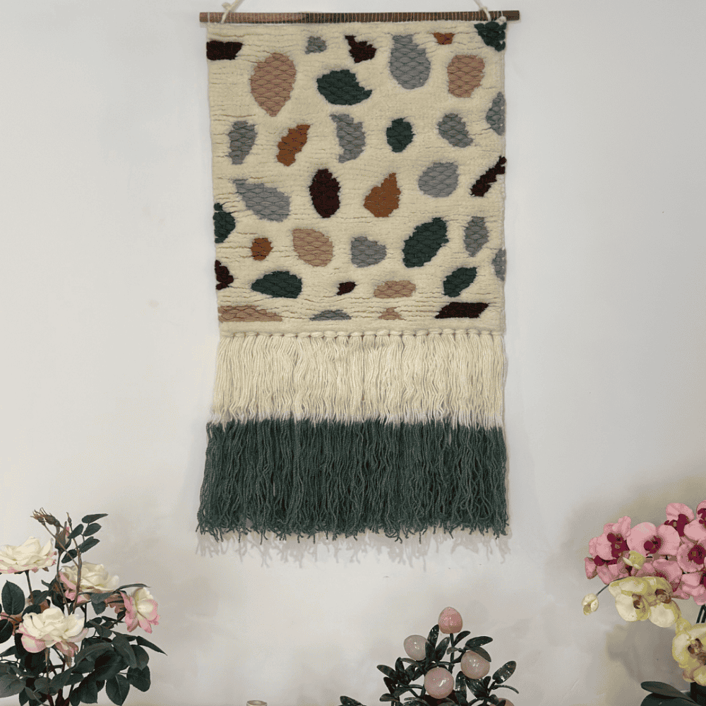 Boho tufted wool wall hanging above a console table