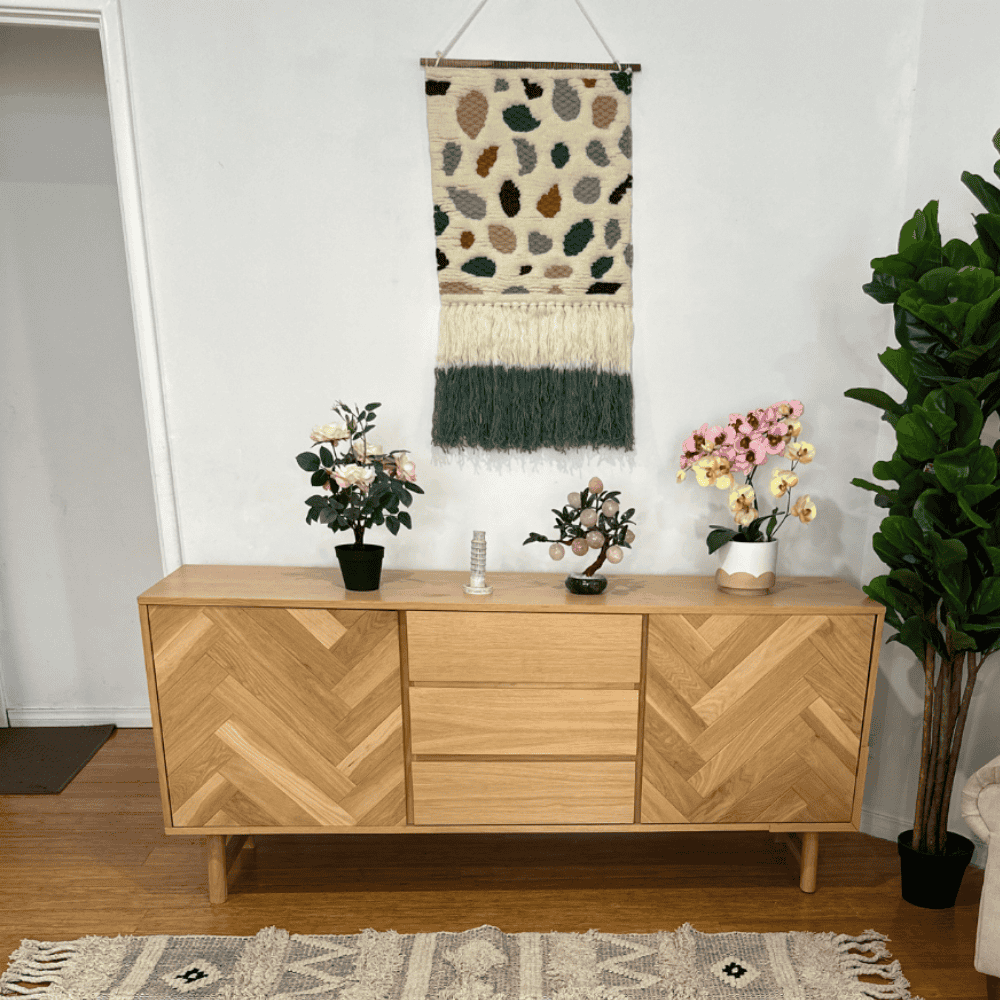 Boho tufted wool wall hanging on a plain wall