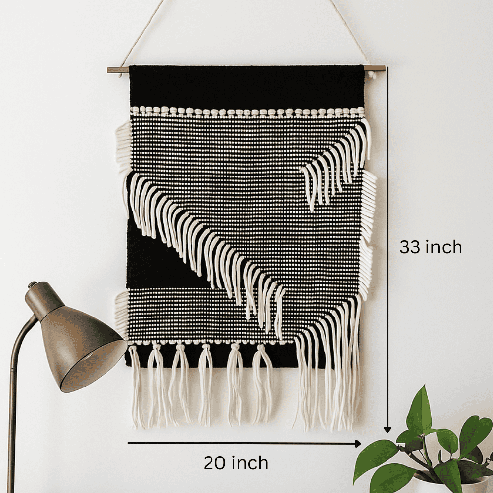 Monochrome cotton fringe wall hanging shown at an angle