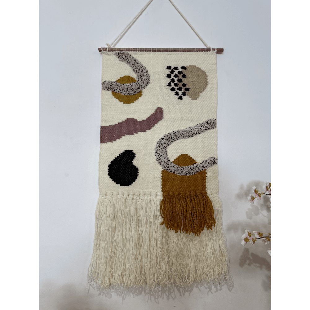 Layered fringe wool wall hanging detail of the wood rod