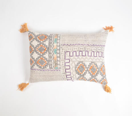 Printed embroidered lumbar cushion cover styled on a bed