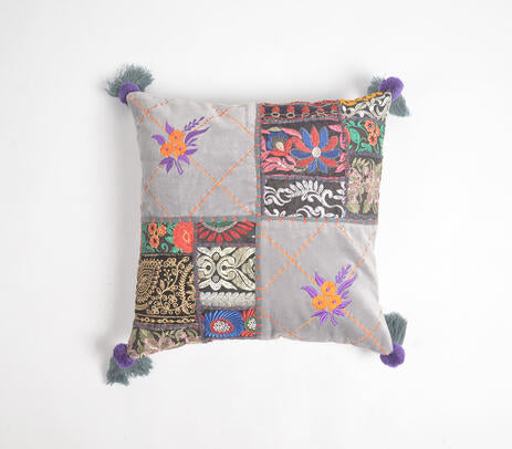 Embroidered patchwork cushion cover paired with other cushions