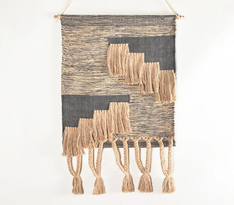 Braided cotton wall hanging shown on a painted plaster wall
