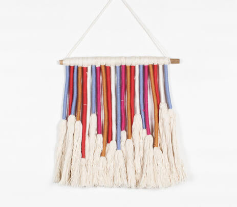 Colourful rope wall hanging above a console table
