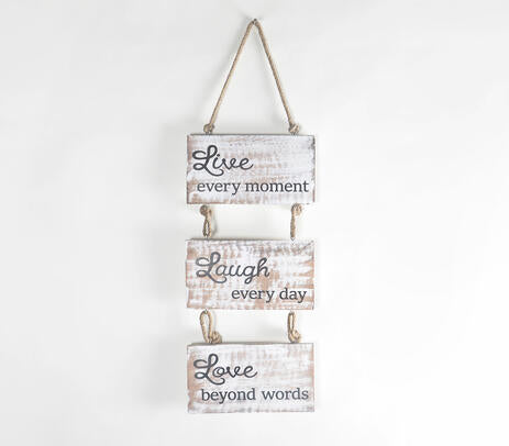 Live Laugh Love wall hanging on a plain wall