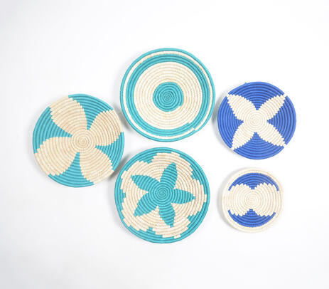 Teal sabai grass wall plates on a pale wall
