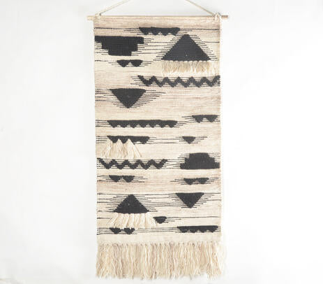 Tribal wool wall hanging above a sofa