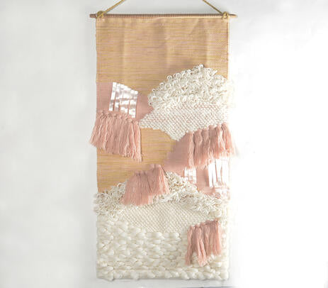 Earthy tufted wool wall hanging on a warm-toned wall