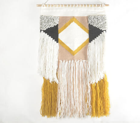Diamond tufted wool wall hanging shown grouped with other wall art