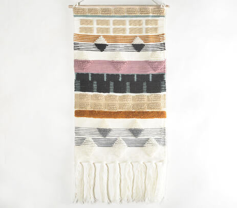 Wool tapestry wall hanging in a styled bedroom
