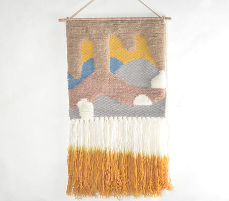 Graded ombre wool wall hanging above a sofa