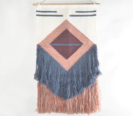 Two tone fringe wool wall hanging above a console table
