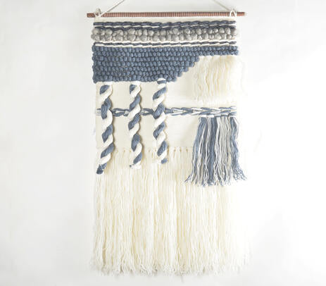 Tufted abstract wool wall hanging in a boho corner