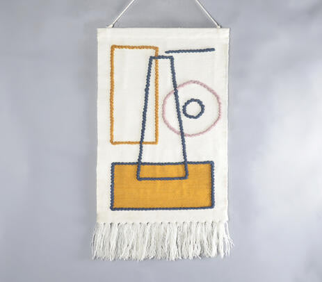 Abstract wool tassel wall hanging above a sofa